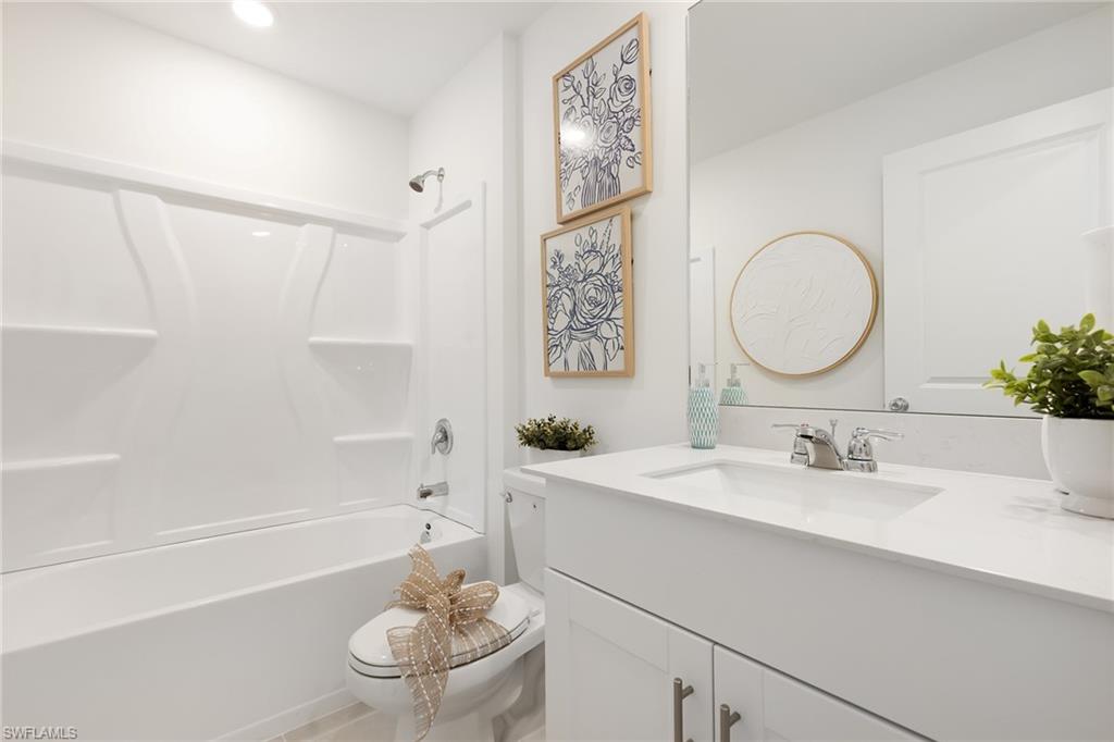 3717 40th Street Southwest Lehigh Acres, FL 33976 - Photo 18 of 30 a bathroom with a sink a toilet and a bathtub