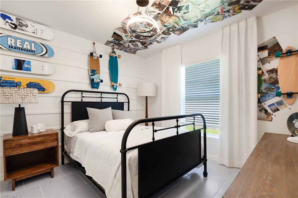 3717 40th Street Southwest Lehigh Acres, FL 33976 - Photo 19 of 30 a bedroom with a bed and a chandelier