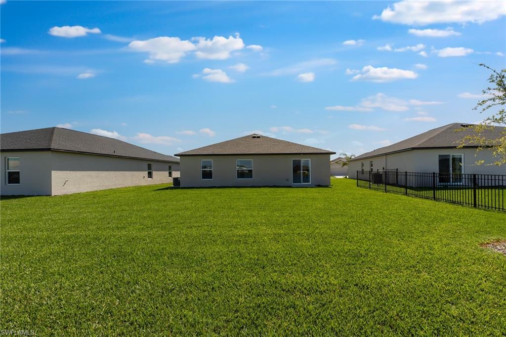 3717 40th Street Southwest Lehigh Acres, FL 33976 - Photo 29 of 30 a front view of the house with a garden