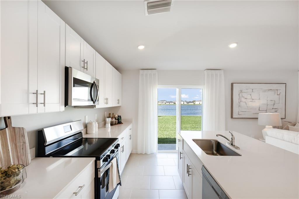 3717 40th Street Southwest Lehigh Acres, FL 33976 - Photo 7 of 30 a kitchen that has a sink and a stove