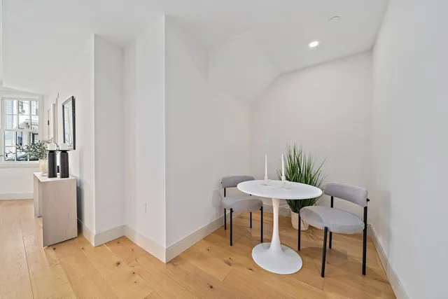 a view of a room with a table and chairs in it