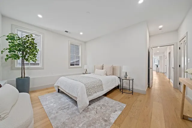 a spacious bedroom with a bed and a couch