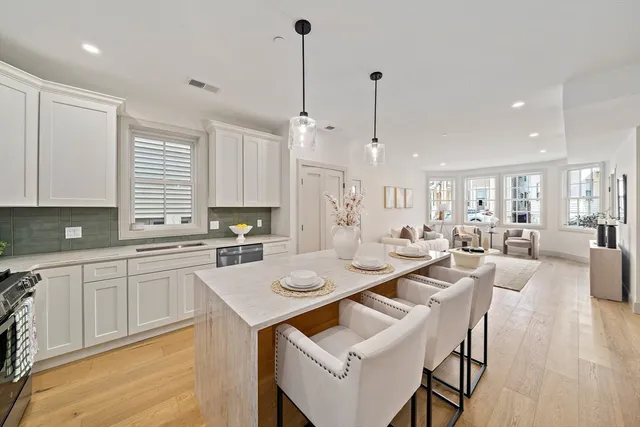 a large kitchen with a table and chairs