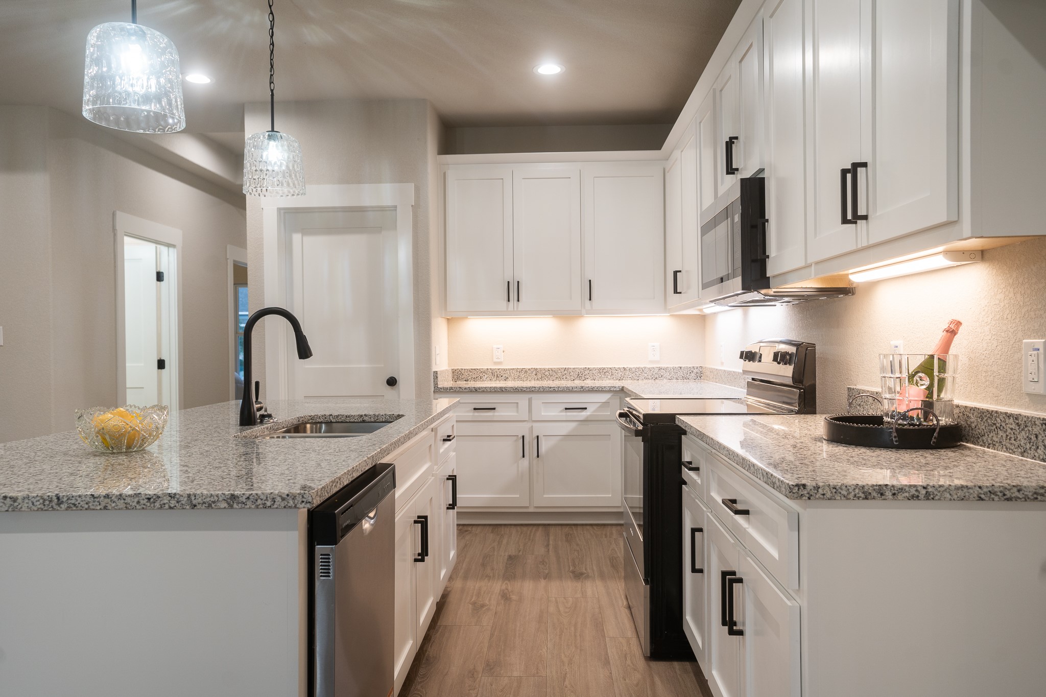 307 String Prairie Way Smithville, TX 78957 - Photo 11 of 34 a kitchen with stainless steel appliances granite countertop a sink stove and cabinets