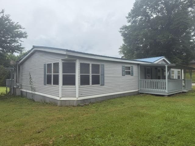 1100 Pine Top Road Toone, TN 38381 - Photo 2 of 40 Single-story residence featuring light gray siding with a blue metal roof