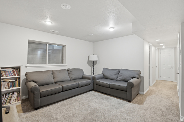 5788 Walden Ridge Drive Murray, UT 84123 - Photo 18 of 29 Carpeted recreation room featuring white walls, recessed lighting, and a single window with blinds