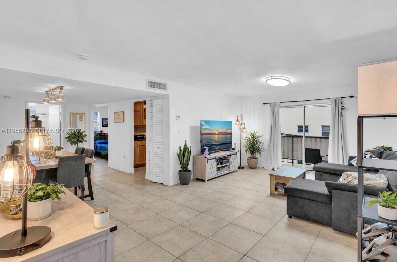 1236 Alton Road, Unit 304 Miami Beach, FL 33139 - Photo 1 of 28 a living room with furniture a fireplace and a flat screen tv