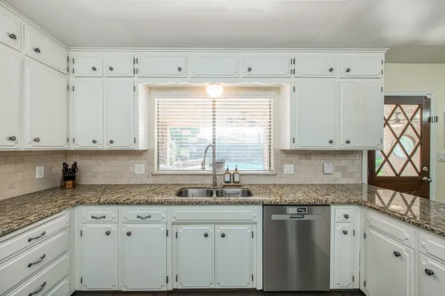 a view of a backyard with sitting area and tree s