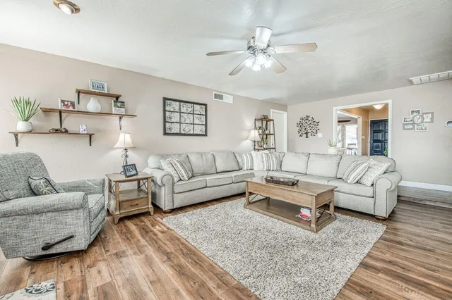 a living room with furniture and a floor to ceiling window