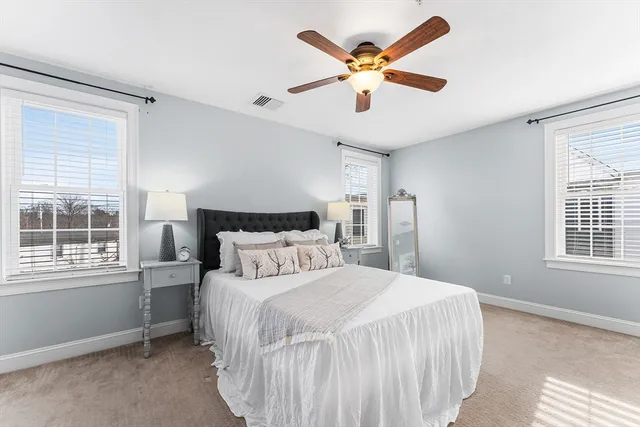 a bedroom with a large bed and a window