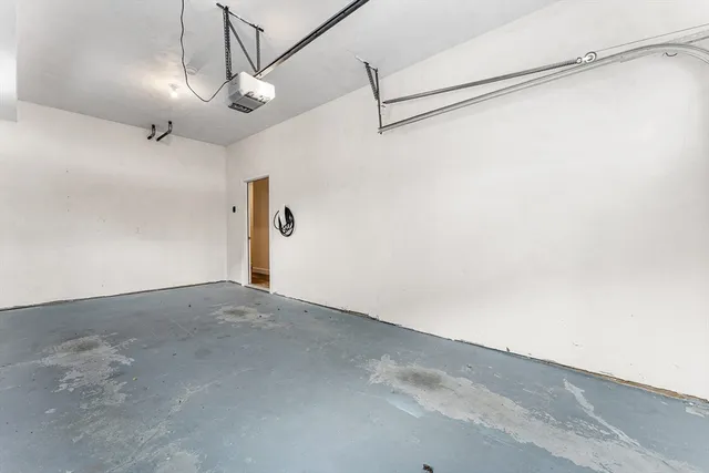 a view of a room with a chandelier fan