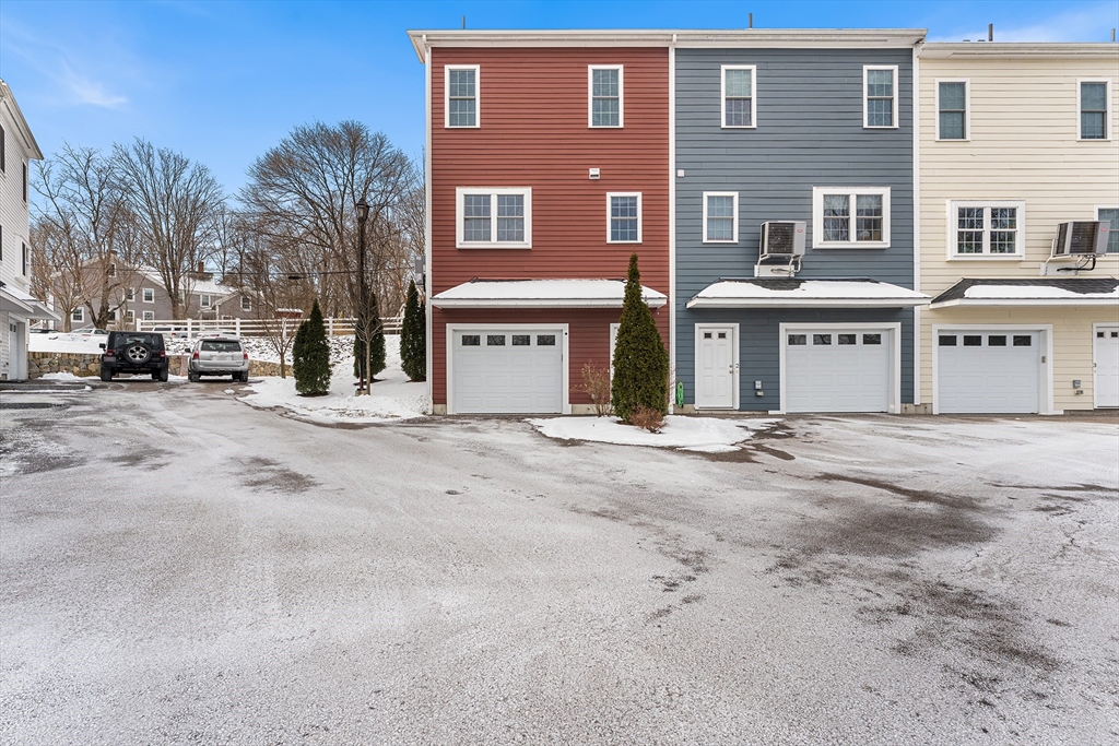 2 Mechanic Street, Unit 1 Medway, MA 02053 - Photo 29 of 32 a front view of a building with lot of cars parked on road