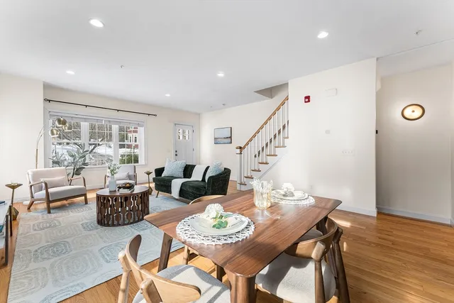 a view of a dining room with furniture window and wooden floor