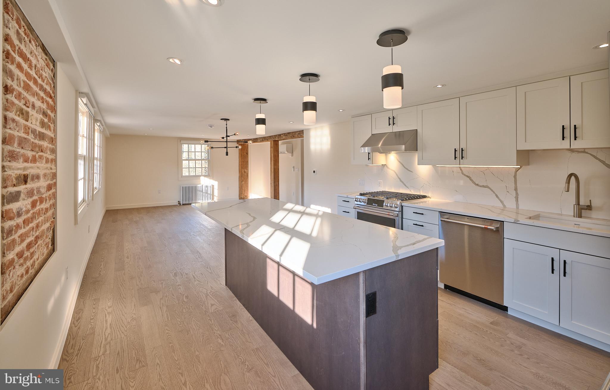 44 South Main Street, Unit 2N New Hope, PA 18938 - Photo 23 of 23 a kitchen with kitchen island a sink appliances and cabinets