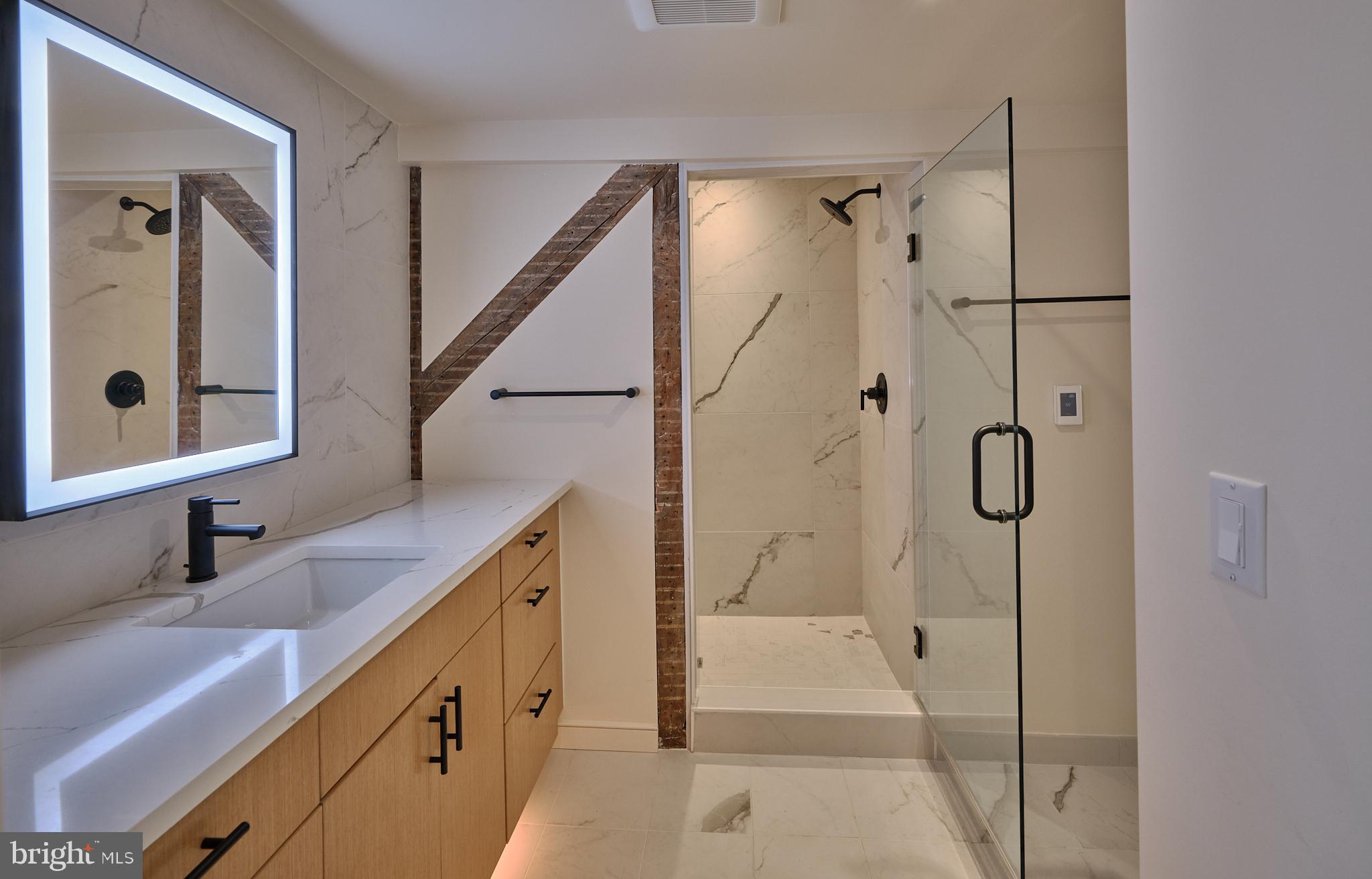 44 South Main Street, Unit 2N New Hope, PA 18938 - Photo 4 of 23 a bathroom with a double vanity sink mirror and shower