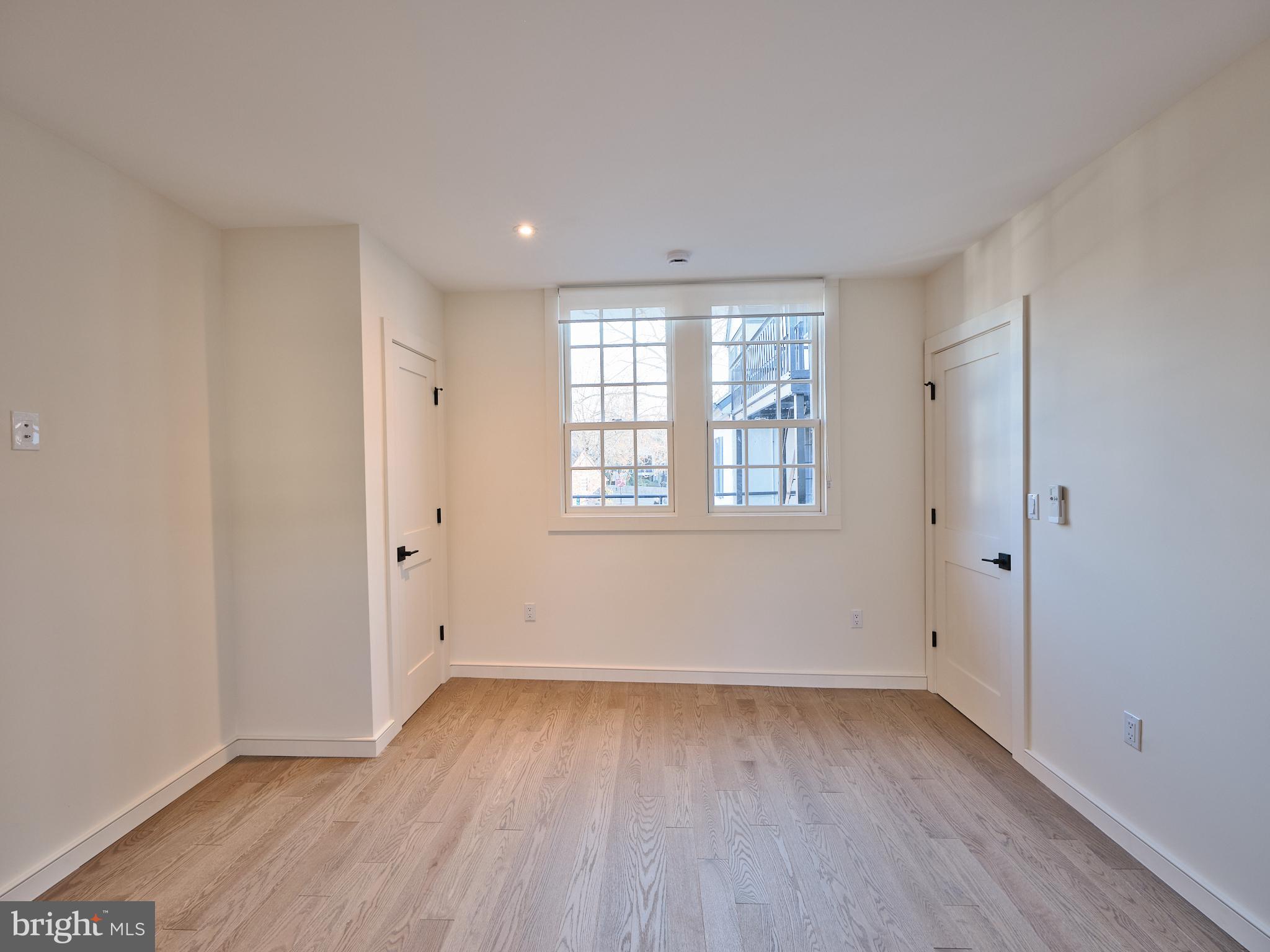 44 South Main Street, Unit 2N New Hope, PA 18938 - Photo 9 of 23 wooden floor in an empty room with a window
