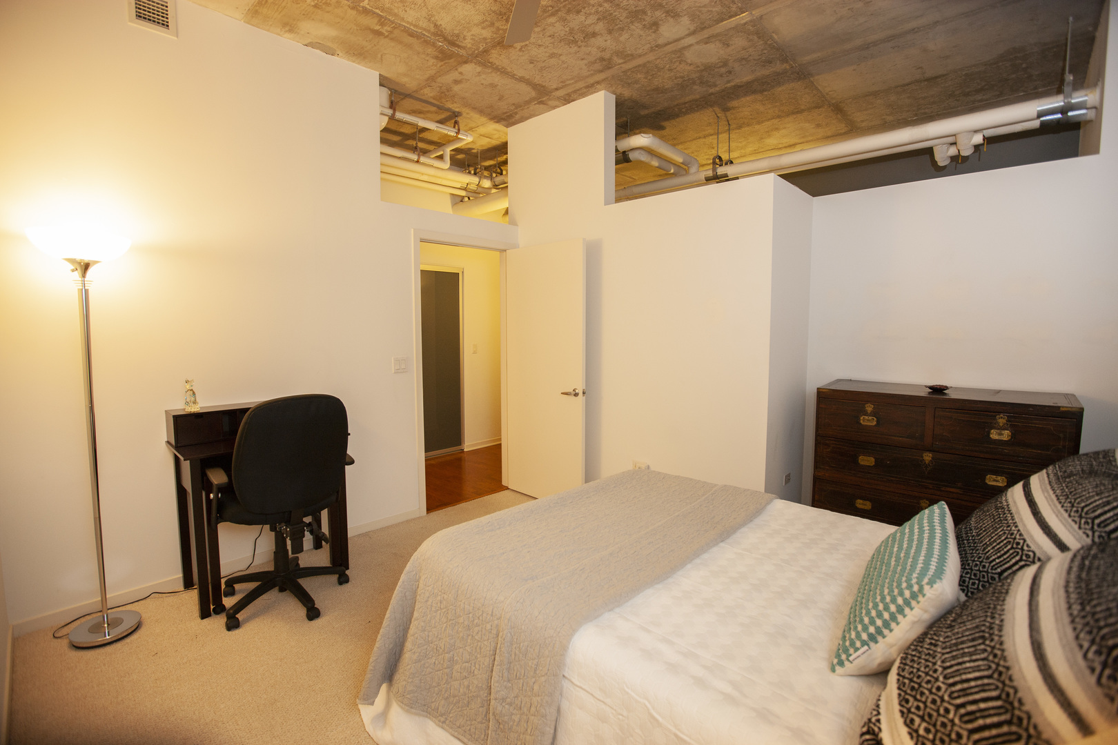 807 Davis Street, Unit 505 Evanston, IL 60201 - Photo 11 of 17 a bedroom with a bed and chair