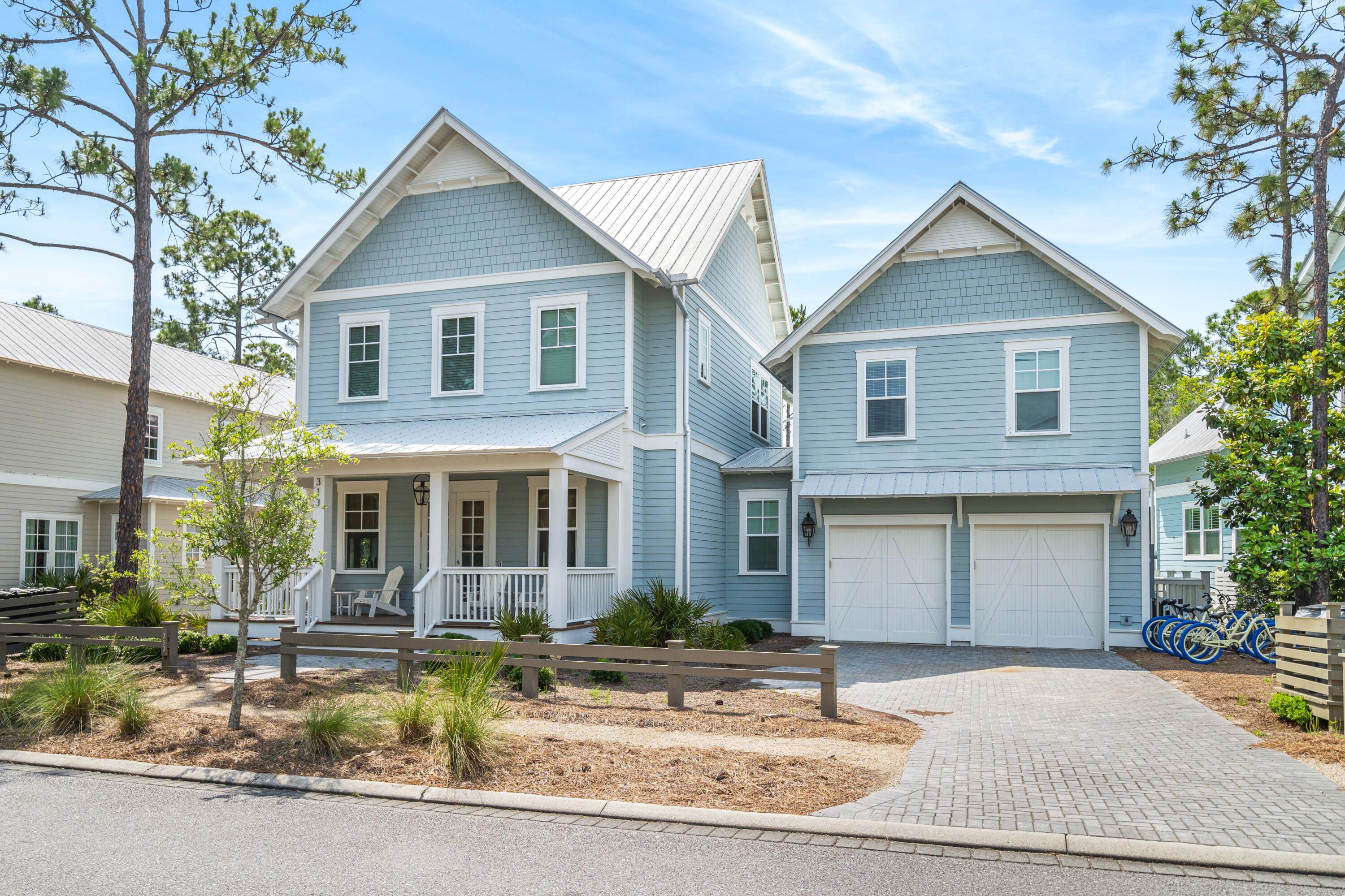 313 East Royal Fern Way Santa Rosa Beach, FL 32459 - Photo 2 of 48 a front view of a house with garden and sitting area