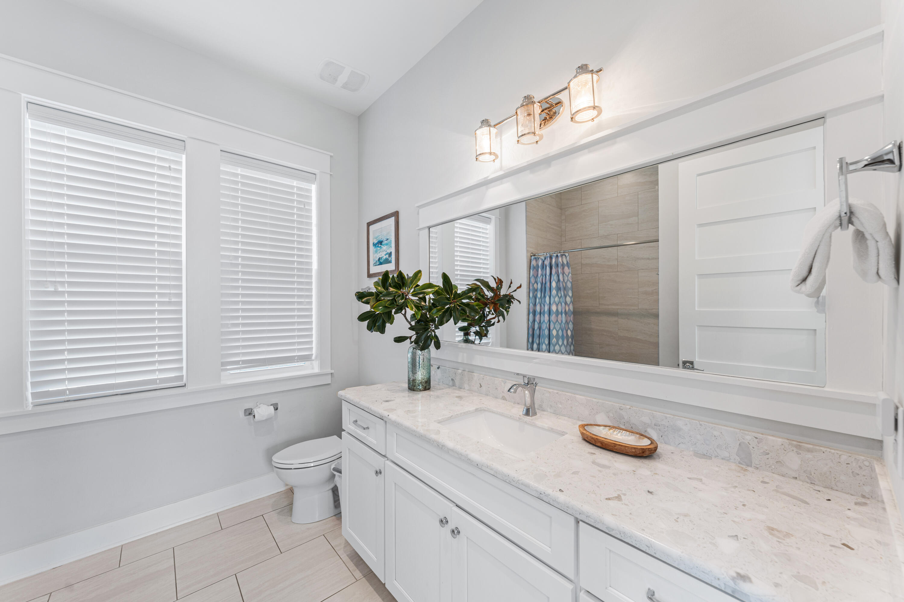 313 East Royal Fern Way Santa Rosa Beach, FL 32459 - Photo 29 of 48 a bathroom with a granite countertop sink a large mirror a toilet and a window