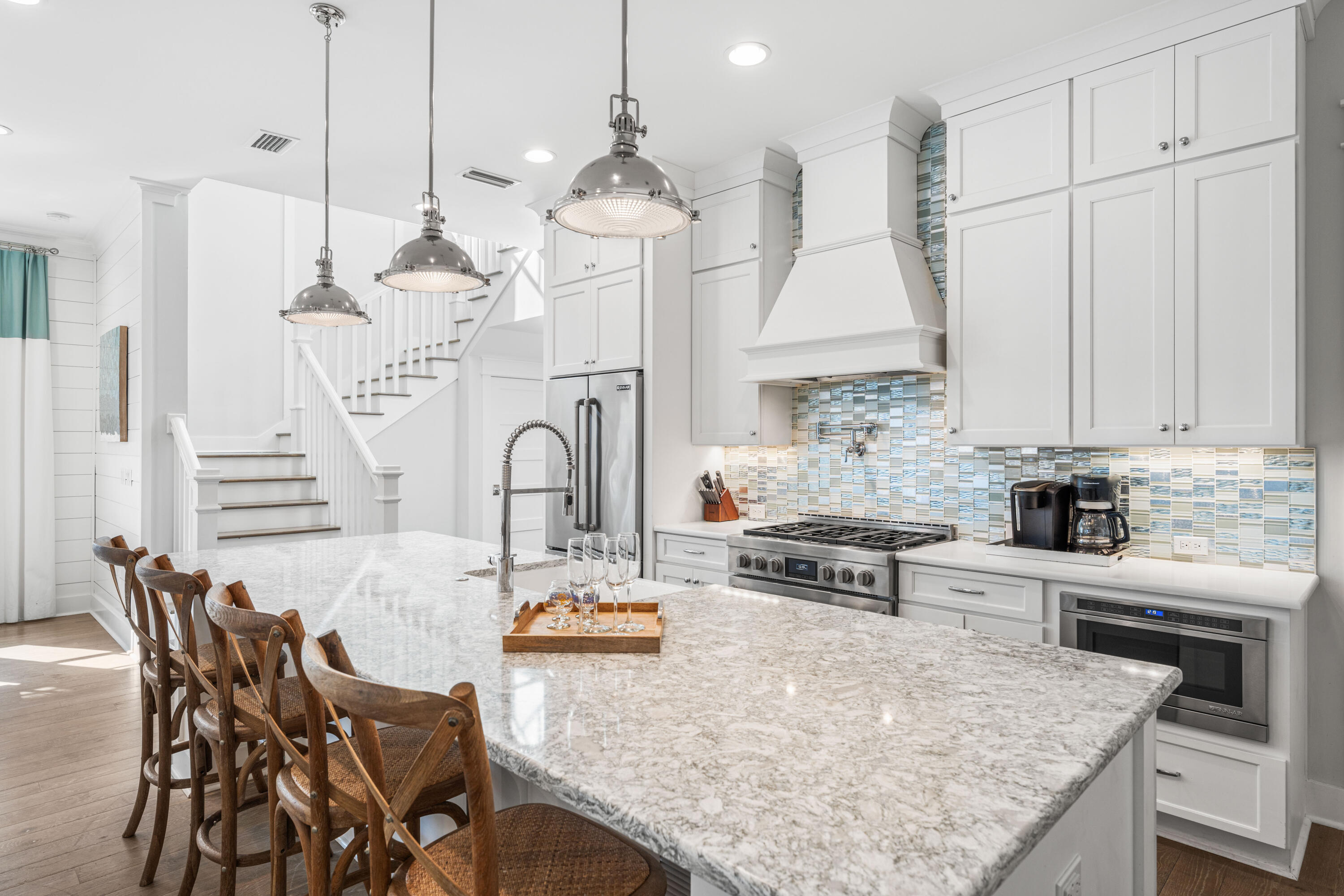 313 East Royal Fern Way Santa Rosa Beach, FL 32459 - Photo 4 of 48 a kitchen with stainless steel appliances kitchen island granite countertop a table chairs in it and white cabinets