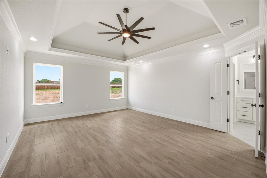 3155 Infinity Drive Weatherford, TX 76087 - Photo 18 of 39 Unfurnished room featuring a ceiling fan, wood finish floors, ornamental molding, plenty of natural light, and recessed lighting