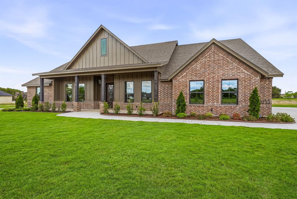 3155 Infinity Drive Weatherford, TX 76087 - Photo 2 of 39 Craftsman-style house featuring covered porch, brick siding, board and batten siding, and a front yard