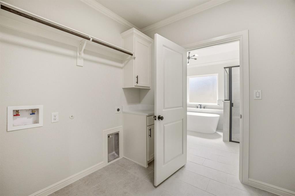 3155 Infinity Drive Weatherford, TX 76087 - Photo 25 of 39 Laundry area with crown molding, electric dryer hookup, gas dryer hookup, washer hookup, and cabinet space