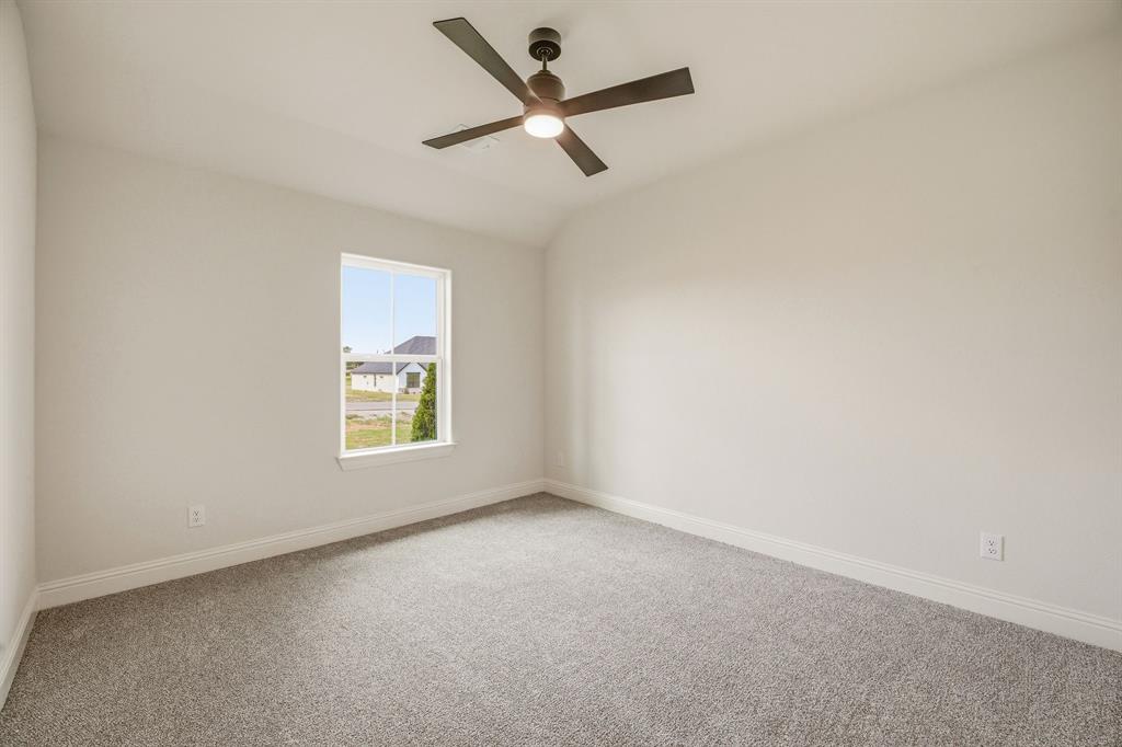 3155 Infinity Drive Weatherford, TX 76087 - Photo 26 of 39 Carpeted empty room with ceiling fan and vaulted ceiling