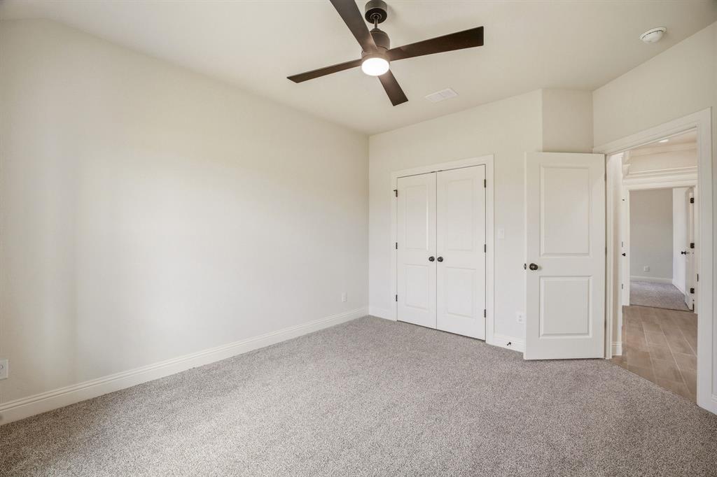 3155 Infinity Drive Weatherford, TX 76087 - Photo 27 of 39 Unfurnished bedroom featuring carpet floors, ceiling fan, and a closet