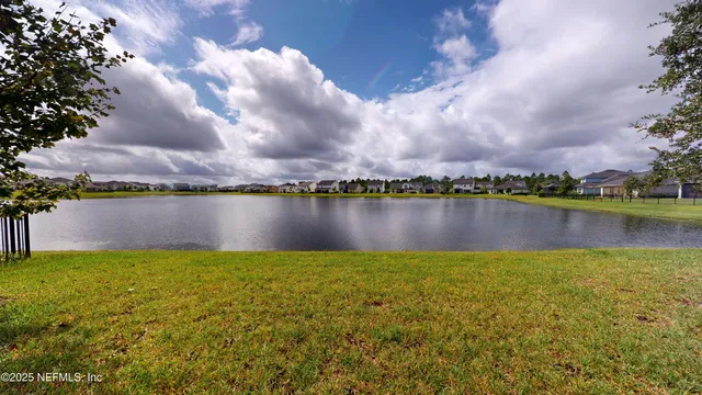 a view of a lake with houses in the back