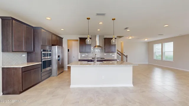 a large kitchen with stainless steel appliances kitchen island granite countertop a large counter top stainless steel appliances and cabinets