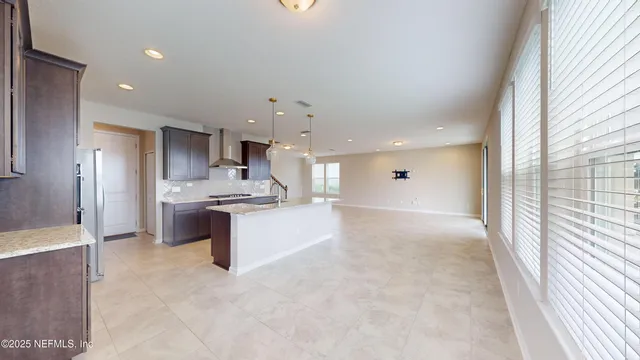 a view of kitchen with kitchen island sink and refrigerator
