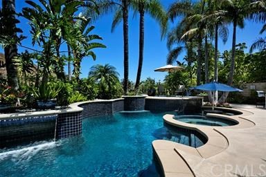 28362 Via Pasito San Juan Capistrano, CA 92675 - Photo 3 of 14 a view of a swimming pool with a table and chairs under an umbrella
