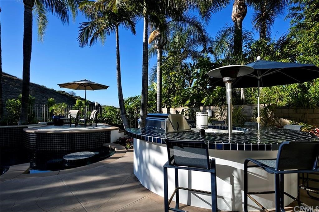 28362 Via Pasito San Juan Capistrano, CA 92675 - Photo 5 of 14 a patio table and chairs under an umbrella