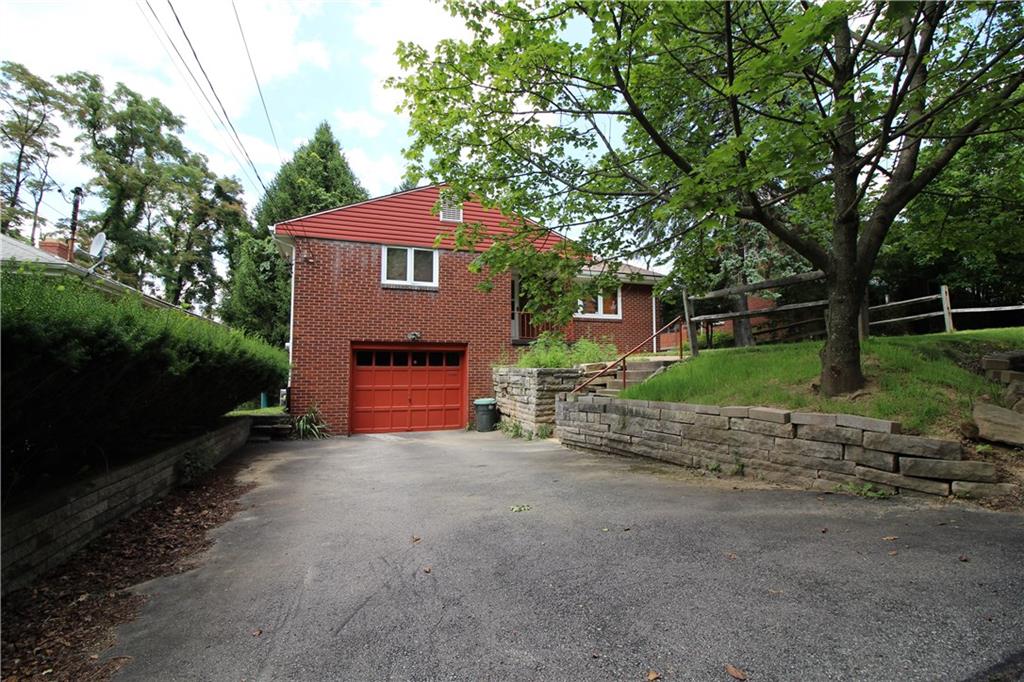 10109 Pearl Road Pittsburgh, PA 15235 - Photo 17 of 23 The driveway is built to fit up to 4 cars, and an additional cut-out to the right provides extra off-street parking. Landscaping in the front provides privacy and shade.