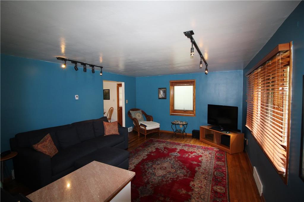 10109 Pearl Road Pittsburgh, PA 15235 - Photo 3 of 23 The spacious living room is a delight to enter, with hardwood floors, wood-cased Pella windows and wood blinds, marble sills, and track lighting.