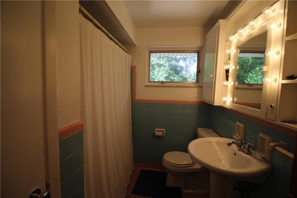 10109 Pearl Road Pittsburgh, PA 15235 - Photo 7 of 23 The clean and well-maintained bathroom features ceramic wall surround, linen closet, and updated pedestal sink, toilet, and fixtures.