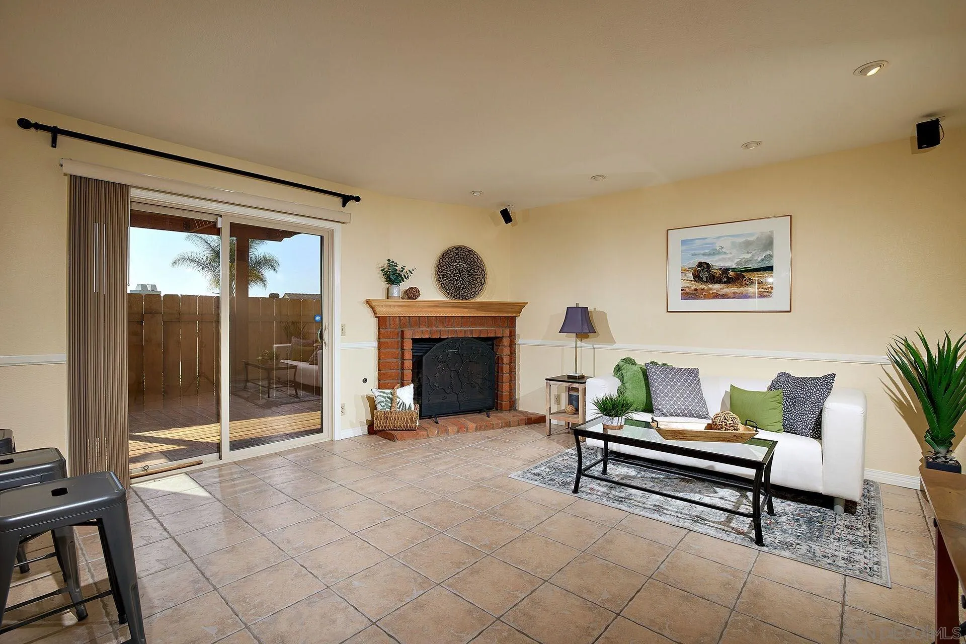 3007 Ruttles Court Spring Valley, CA 91978 - Photo 14 of 22 a living room with furniture a fireplace and a floor to ceiling window