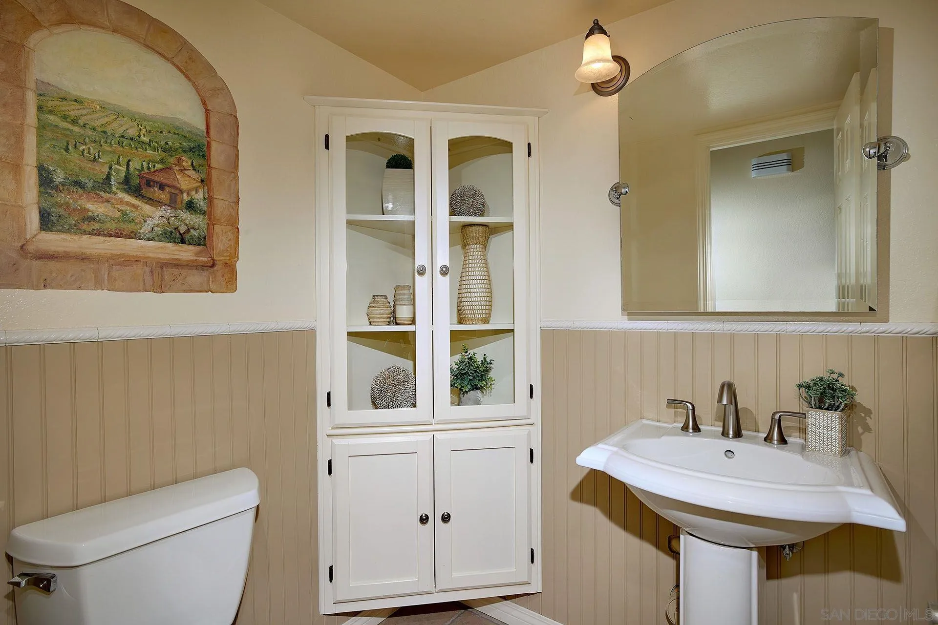 3007 Ruttles Court Spring Valley, CA 91978 - Photo 16 of 22 a bathroom with a toilet a sink and a mirror