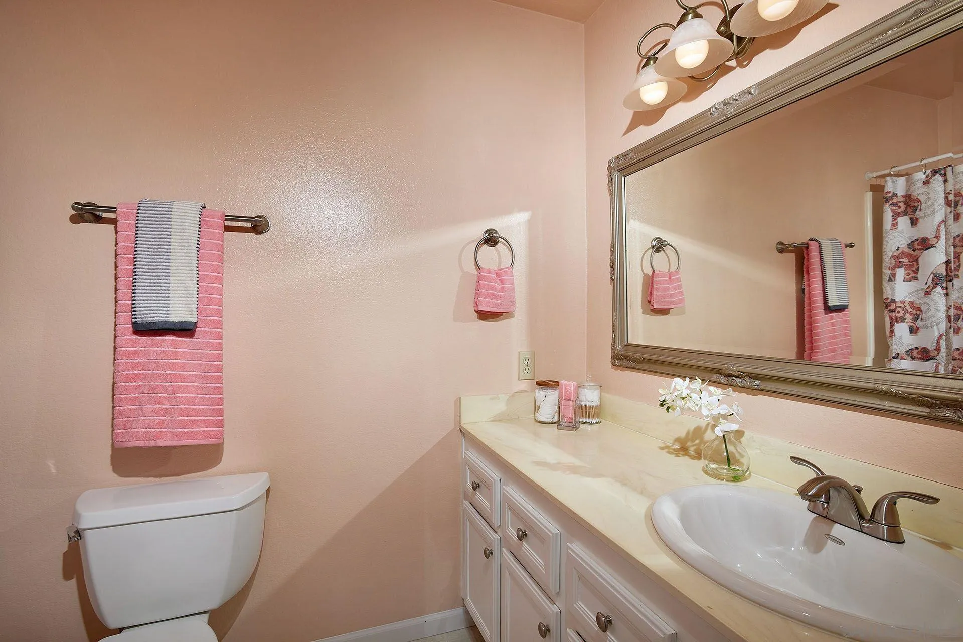 3007 Ruttles Court Spring Valley, CA 91978 - Photo 22 of 22 a bathroom with a granite countertop sink a toilet and a mirror