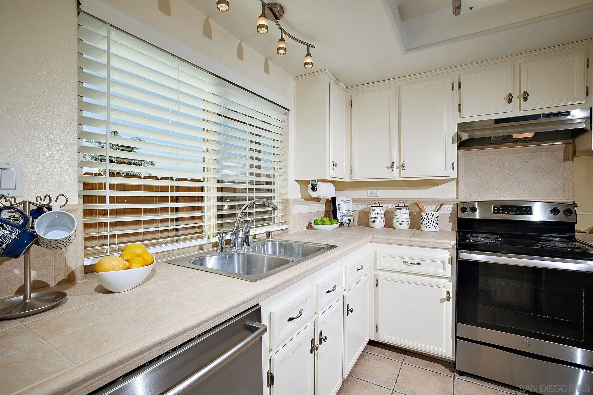 3007 Ruttles Court Spring Valley, CA 91978 - Photo 5 of 22 a kitchen with a sink appliances and cabinets