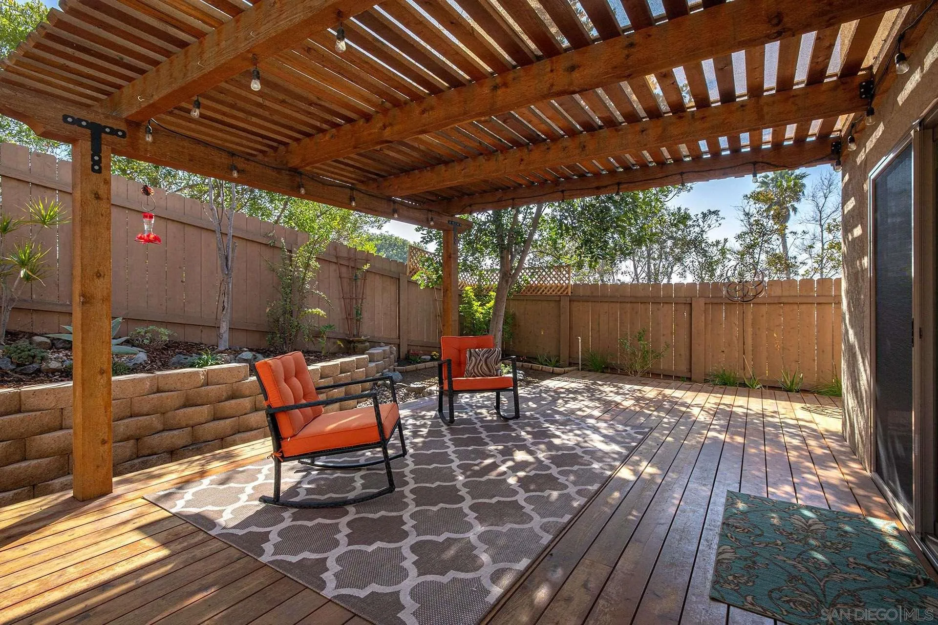 3007 Ruttles Court Spring Valley, CA 91978 - Photo 9 of 22 a view of a patio with table and chairs with wooden floor