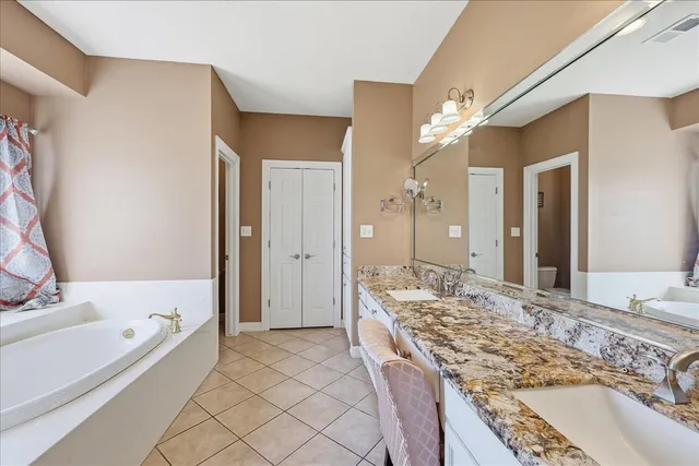 a large spacious bathroom with a large tub shower and sink