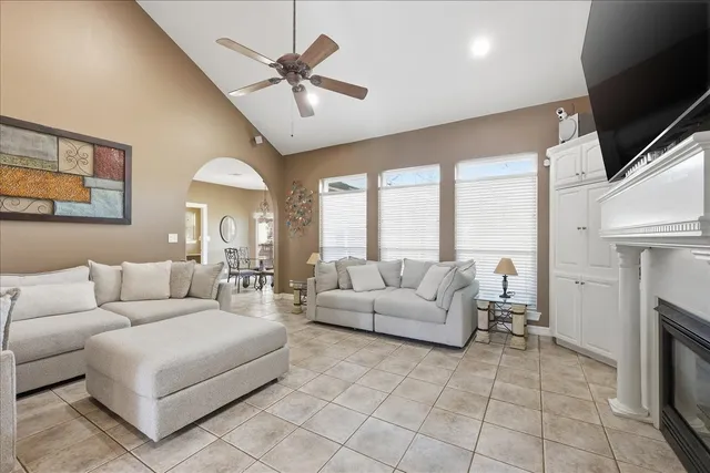 a living room with furniture a fireplace and a flat screen tv