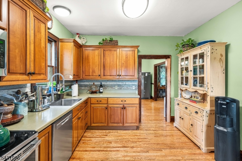 886 Brass Castle Road Belvidere, NJ 07823 - Photo 15 of 44 a kitchen with stainless steel appliances granite countertop a refrigerator a sink dishwasher and wooden cabinets with wooden floor