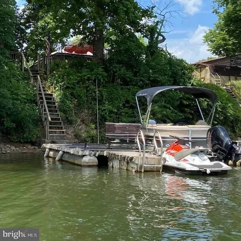 a small pool with lawn chairs