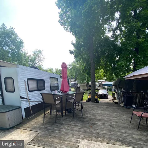 a view of a chair and tables in the patio