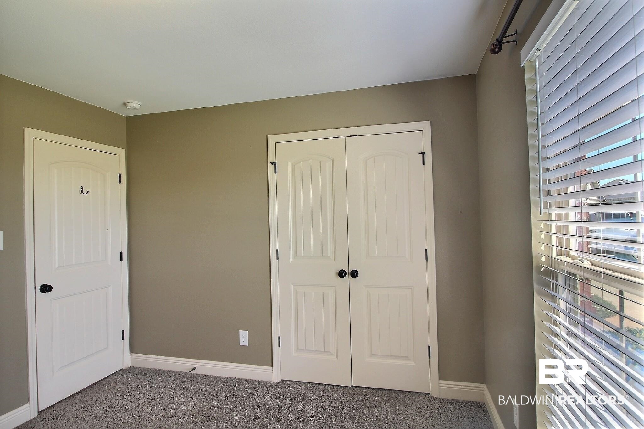 15577 Talus Court Foley, AL 36535 - Photo 12 of 28 Unfurnished bedroom with carpet floors and a closet