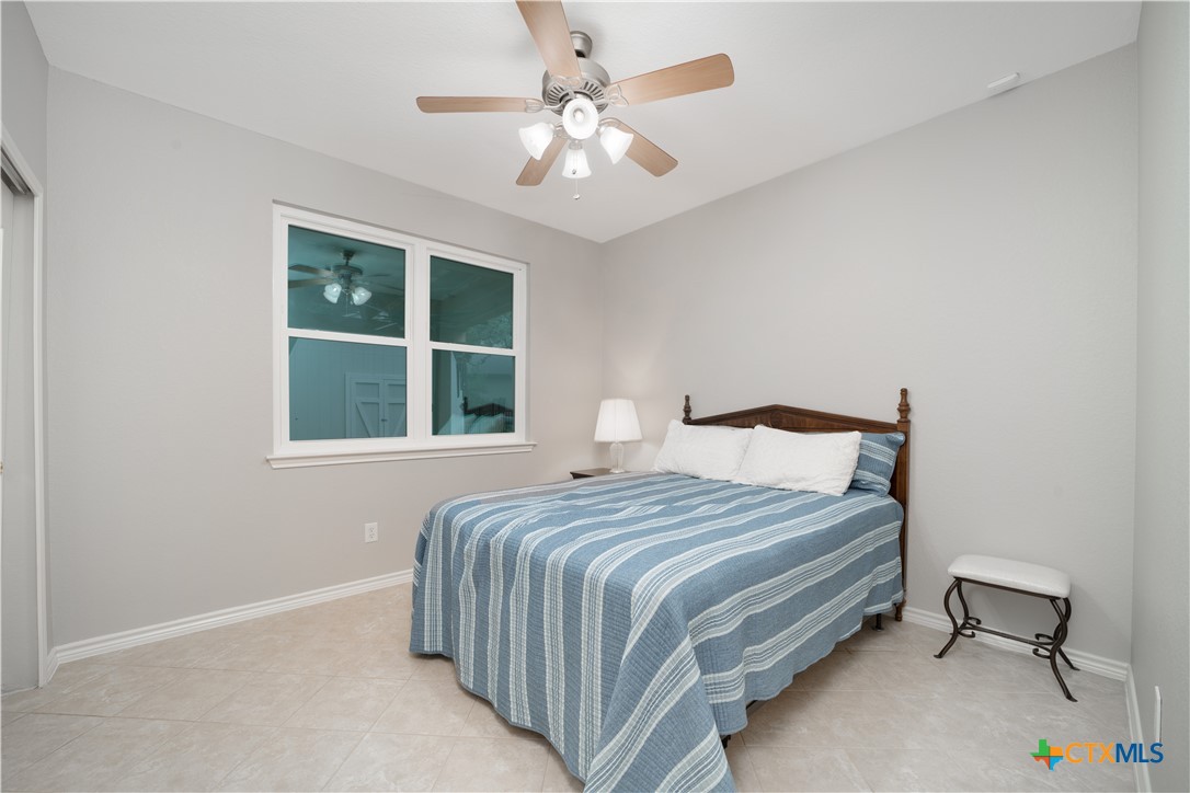 103 Sierra Ridge Drive San Marcos, TX 78666 - Photo 19 of 43 a bedroom with a bed and a window