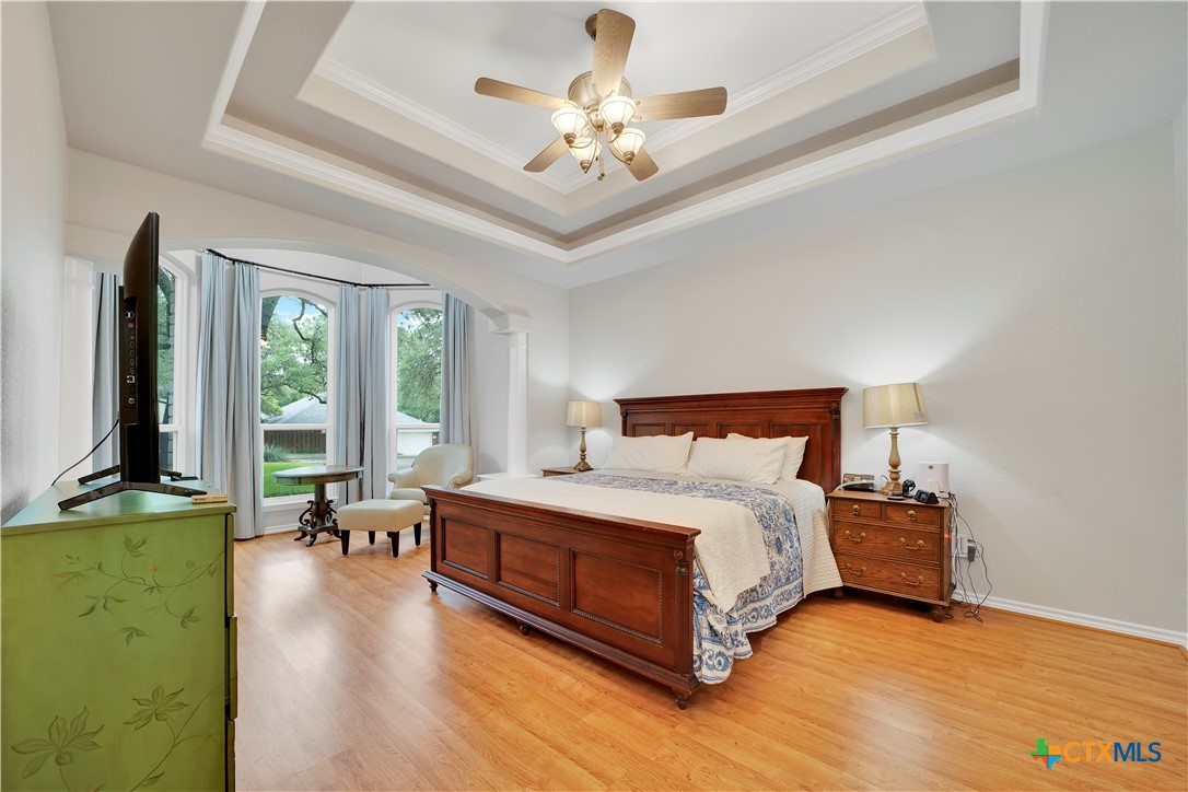 103 Sierra Ridge Drive San Marcos, TX 78666 - Photo 23 of 43 a spacious bedroom with a bed and a chandelier